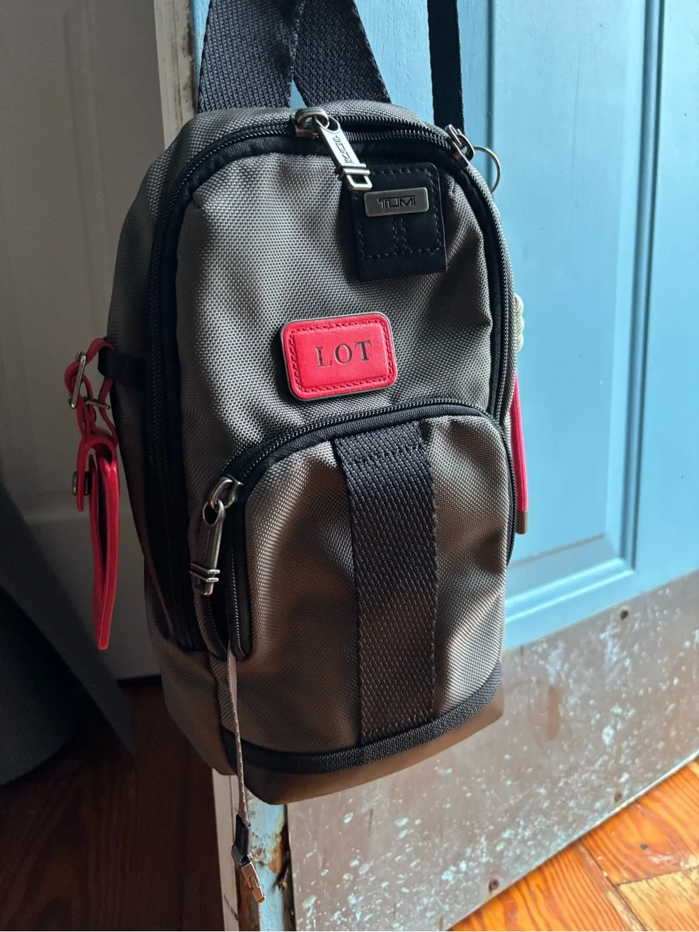 Tumi FIFE Gray SLIM Sling Bag dark grey and black.